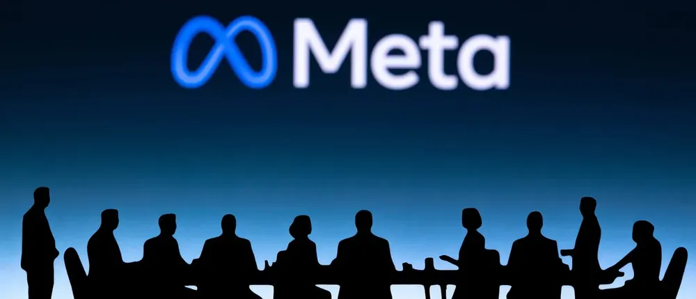Meta logo above silhouettes of people seated around a meeting table
